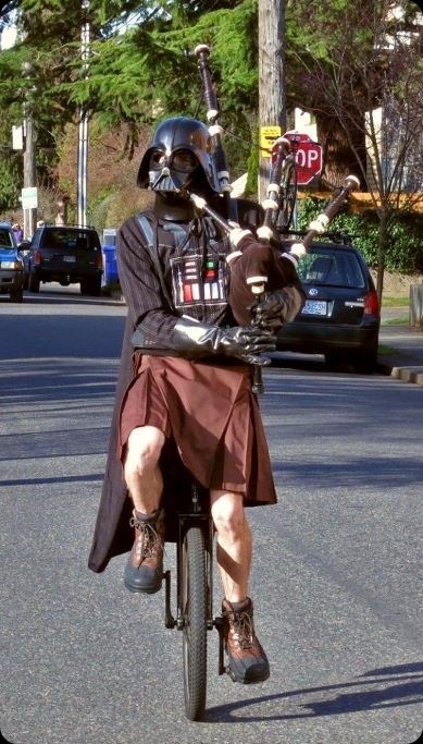 a-person-in-a-Darth-Vader-mask-and-cape-and-a-kilt-riding-a-unicycle-playing-Star-Wars-music-on-a-bagpipe_thumb3.jpg